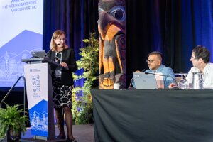 Amer Igal at panel podium sign totem 